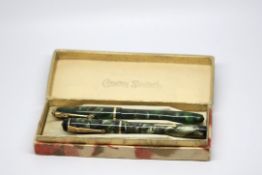 A boxed set of vintage Conway Stewart dinky fountain pens, with original box