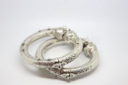 A pair of over signed heavy Eastern hinged bangles, engraved design, Eastern silver marks, 12cm