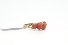 L19th century coral five stone ring, five graduating oval coral cabochons mounted in closed back