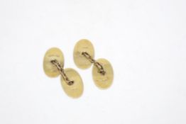 Pair of 9ct yellow gold oval cufflinks with engraved detailing, weighing approximately 3.1g