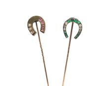 Pair of Victorian horseshoe stick pins, one set with emeralds and old cut diamonds, the other ruby