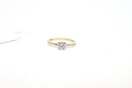 Single stone cubic zirconia ring, with cubic zirconia shoulders, mounted in 9ct yellow gold,