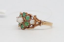 Opal and emerald cluster ring, central opal surrounded by emeralds, with opal set shoulders, mounted