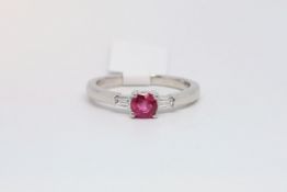 Ruby and diamond three stone ring, round cut ruby to the centre, with a tapered baguette cut diamond