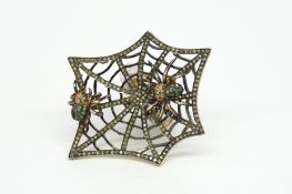 An abstract spider and web gem set ring, diamond set web with two gem set spiders, measures 5 x 4cm,