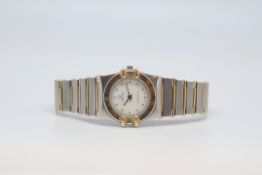 Ladies' Omega constellation, white dial with dot hour markers, gold bezel with Roman numerals, steel