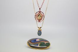 Three items of costume jewellery, including two pendants and an agateware pottery brooch