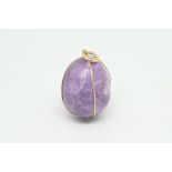 Quartz egg pendant, with a yellow metal wire surround stamped 18ct