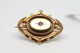 Victorian morning brooch, set with a single ruby, glass locket back, 4.5x3.5cm, in yellow metal