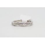 Diamond half eternity ring, round brilliant cut and baguette cut diamonds set in a wave design,