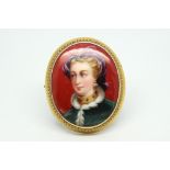 Enamel painted portrait brooch, depicting a lady on a red background, gold mounted with wirework
