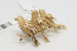 Diamond and gold bird brooch, three textured birds, set with diamond eyes, sitting on a branch,