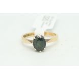 Single stone tourmaline ring, oval cut green tourmaline, eight claw set in 9ct yellow gold,