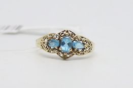 Blue stone ring, three blue stones, set in yellow metal, ring size P