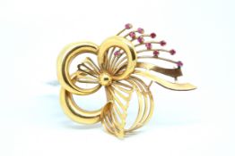 Ruby bow brooch, yellow metal fancy bow, set with a spray of eleven round cut rubies, stamped 750,