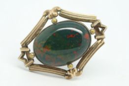 Stone set brooch, central oval cut bloodstone, set within a decorative silver mount, locket back