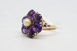 Amethyst and pearl floral ring, central pearl with six pear cut amethysts, further pearl detail,