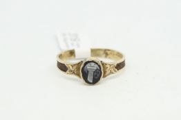 Memorial ring, central oval cameo, with carved detail to the shoulders and braided hair to the