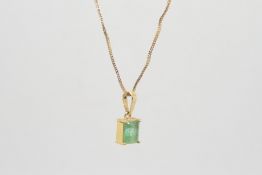 Single stone emerald pendant, rectangular emerald measuring 5.7 x 7.5mm, claw set in yellow metal