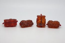 Four carved amber beads