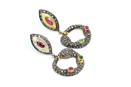 Gem set drop earrings, the drop is designed as a coiled snake, set with an oval cut ruby and an oval