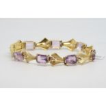 Amethyst set bracelet, rectangular cut amethysts spaced with textured gold panels, hallmarked