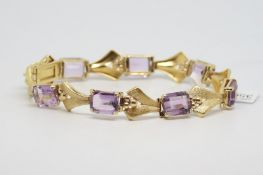 Amethyst set bracelet, rectangular cut amethysts spaced with textured gold panels, hallmarked