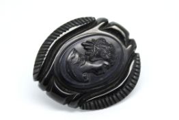 French jet brooch, central carved detail depicting a maiden, within an ornate carved surround