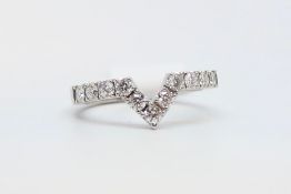 Diamond 'V' shaped half eternity ring, eleven round brilliant cut diamonds weighing an estimated 0.