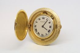 A vintage Bueche-Girod miniature travel clock, circular white dial with Roman numerals and outer