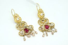 Red stone and pearl fancy earrings, decorative drops set with a central oval cut red stone, with