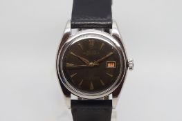 Vintage Rolex Oyster Perpetual Date Just, black circular dial, gilt lettering, gold dagger hour