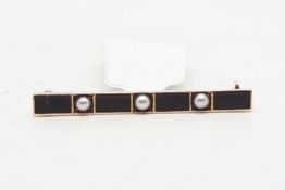 Enamel and seed pearl bar brooch, three split pearls, set between black enamel panels, mounted in