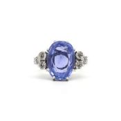 Sapphire and diamond cocktail ring, oval cut sapphire weighing an estimated 9.70ct, with three round