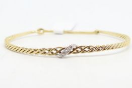 Diamond set bangle, in yellow and white metal stamped 375