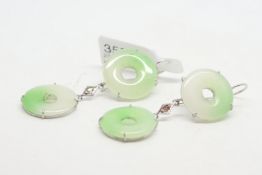 A pair of jade earrings, two circular discs, each separated by a small rose cut diamond, mounted