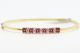 Ruby and diamond hinged bangle, round cut rubies and diamonds set on a 18ct yellow gold bangle,