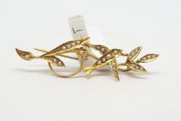 A seed pearl bar brooch, designed as a swallow and leaves, in yellow metal stamped 9ct, length