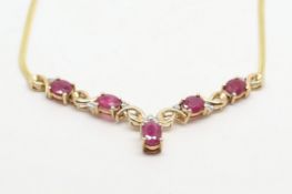 Ruby and diamond necklace, five oval cut rubies, set with diamond detail, on an integrated chain, in