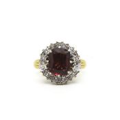 Garnet and diamond cluster ring, central cushion cut garnet weighing an estimated 3.80ct, surrounded