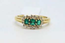 Emerald and diamond cluster ring, three round cut emeralds, surrounded by round brilliant cut