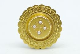 Etruscan style, pearl locket brooch, circular design set with four pearls to the centre and fine