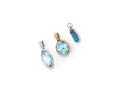 Three pendants, including two topaz pendants set in 9ct gold, and an opal pendant in white metal