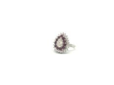 Ruby and diamond cluster ring, central pear cut diamond weighing an estimated 1.07ct, with a