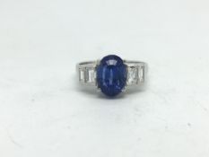 Ceylon sapphire and diamond ring, 4.32ct oval cut sapphire, mounted with stepped baguette cut