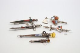 Selection of six mainly silver agate sword and axe brooches