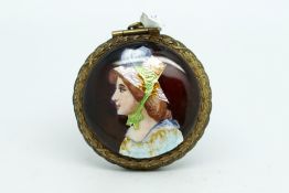 Enamel compact pendant, one side set with a painted enamel lady, the other side enamel flowers, with