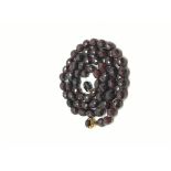 Victorian faceted garnet bead necklace, faceted beads strung to a white metal chain, garnet set gold