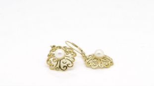 Pair of pearl earrings, single pearl set within a scrolling gold work border, 17mm diameter, in