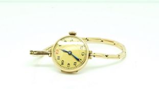 Early 20th Century 14ct ladies wrist watch, gilt dial, Arabic numerals, red 12, 14ct case,